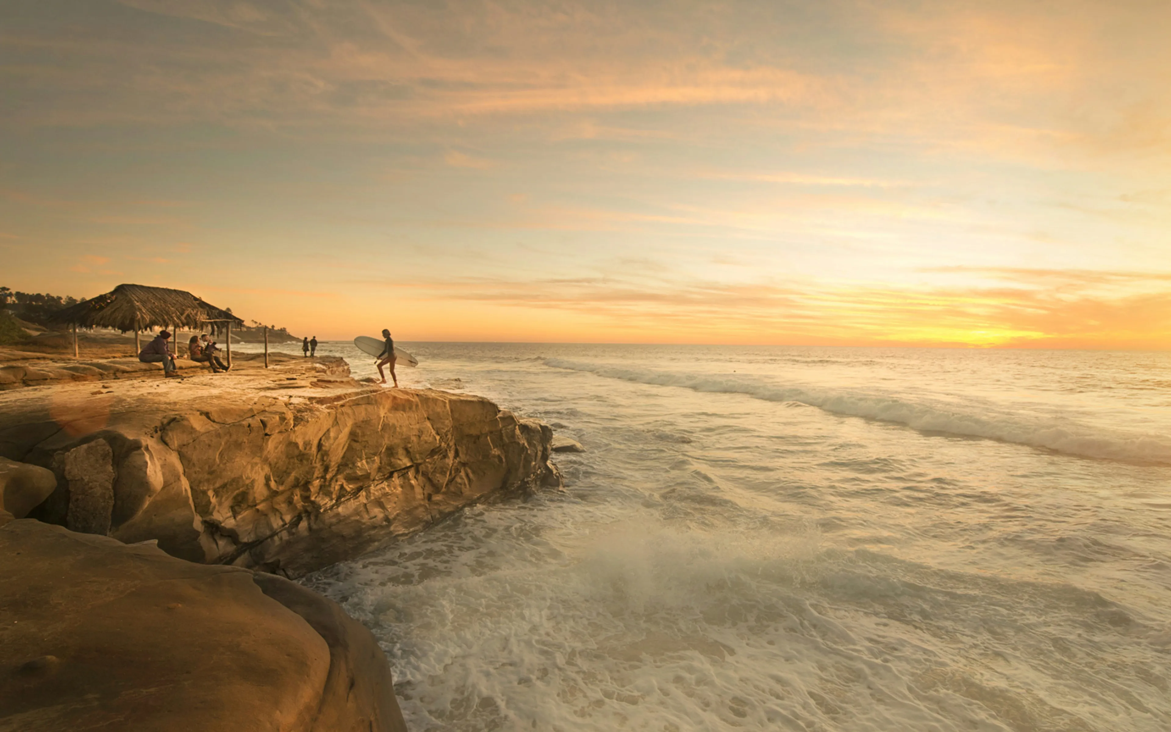 A surfer at sunset in San Diego