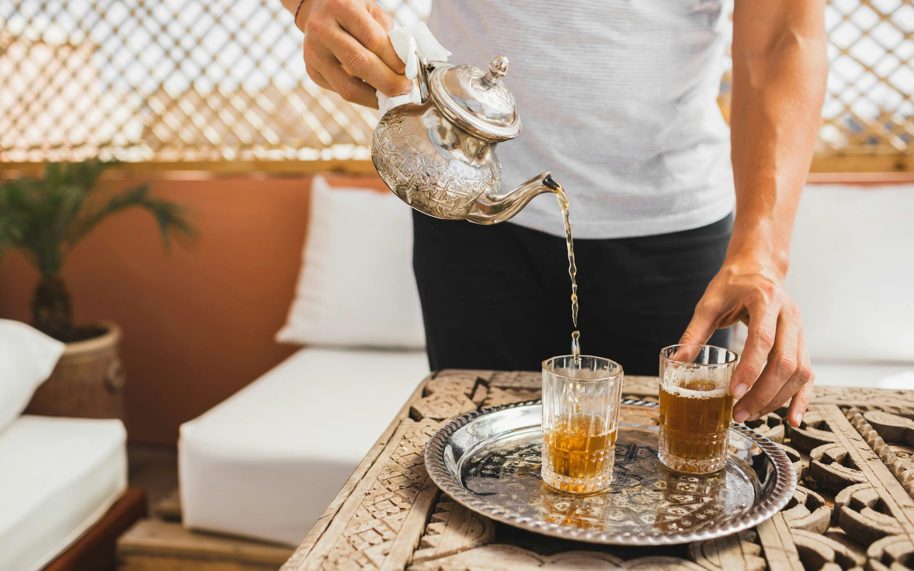 Person pours traditional tea in Marrakesh